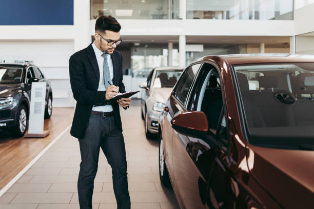 istock Car salesman checking new car 1161966648