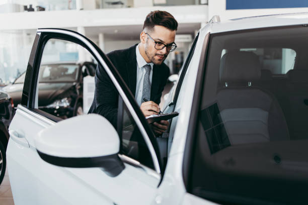 istock Car salesman checking new car 1161967268