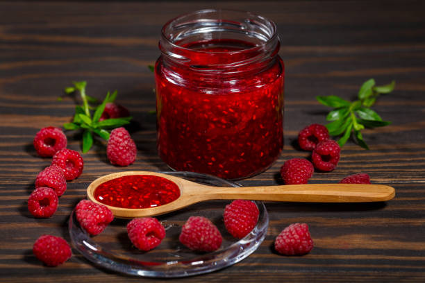 istock Jar of jam and ripe raspberry berries 1161969711
