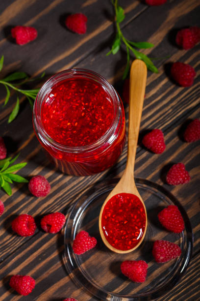 istock Jar of jam and ripe raspberry berries 1161969761