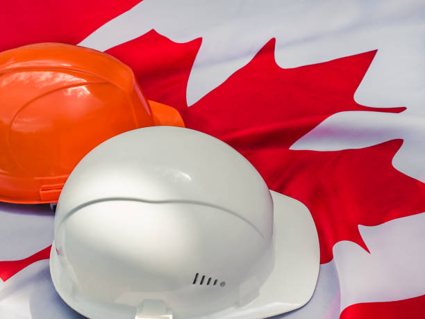 istock Canadian flag and two protective hardhats. Close-up 1161969918
