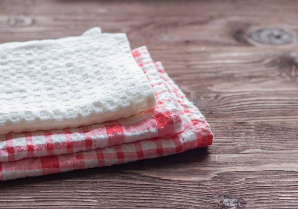 stack of kitchen towels on wooden background
