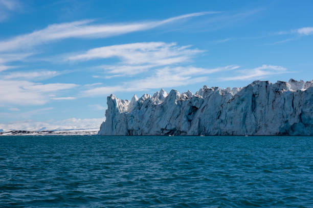 The ocean is very calm in this view of the mountains at the head of Billefjord on the island of Spitsbergen