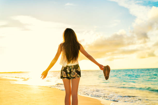 istock Freedom woman carefree dancing relaxing on beach 1161976763