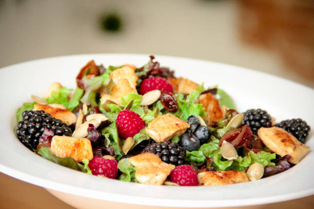 istock Healthy salad bowl with grilled chicken, caramelized onion and berries. 1161977718