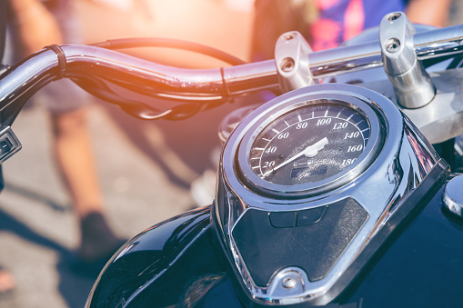 Motorcycle detail with gasoline tank and speedometer. Chrome motorcycle details closeup.