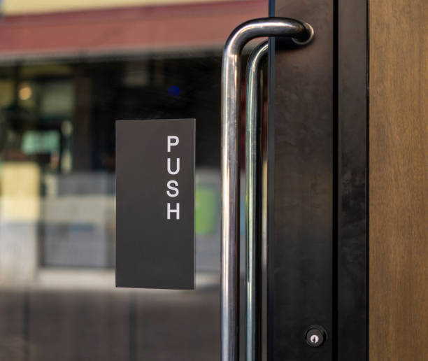 istock Restaurant door handle with push sign on glass doors 1161978215