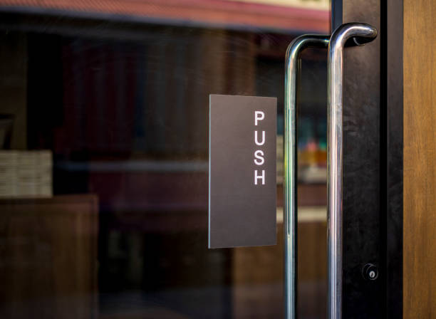 istock Restaurant door handle with push sign on glass doors 1161978222