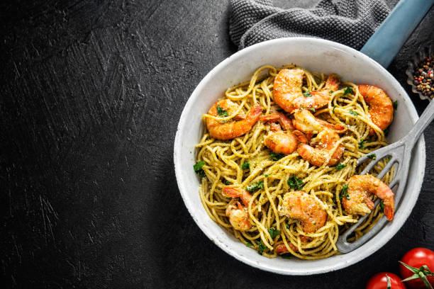 istock Grilled shrimps on pan on dark background 1161980902