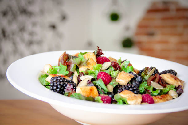 istock Healthy salad bowl with grilled chicken, caramelized onion and berries. 1161981164
