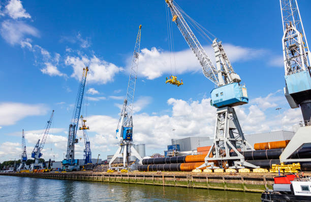 Import export logistics business. Huge cranes at international port of Rotterdam Netherlands, sunny summer day