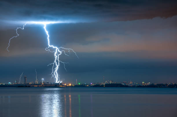 istock lightning strike in a storm over the city 1161982416