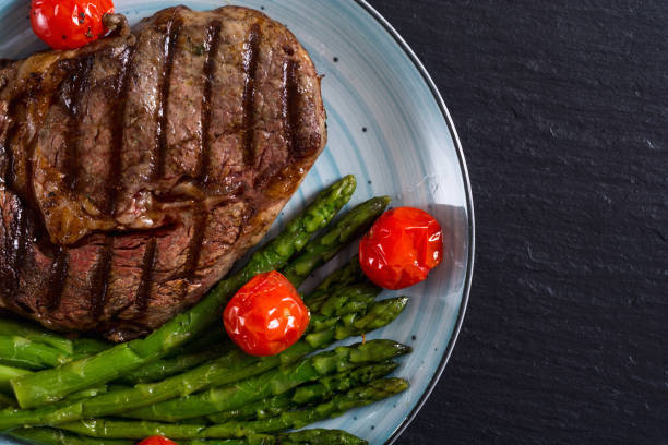 istock Grilled beef steak ribeye with cherry tomatoes and asparagus 1161982522