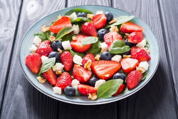 istock Summer Strawberry salad with spinach , cheese , nuts and blueberry 1161982538