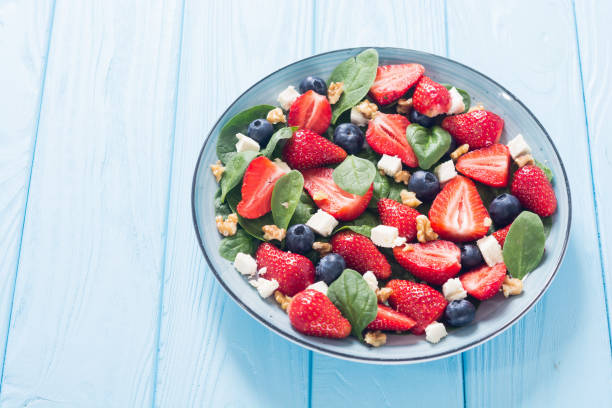 istock Summer Strawberry salad with spinach , cheese , nuts and blueberry 1161982556