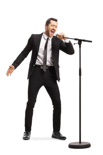 istock Man in a suit singing on a microphone 1161982797