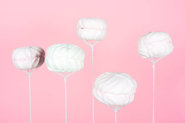 istock Homemade white air meringues on pink background. Balloon from marshmallow . 1161982951