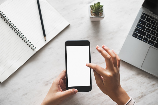 Woman hand using phone with isolated screen for internet online shopping and social media concept, top view