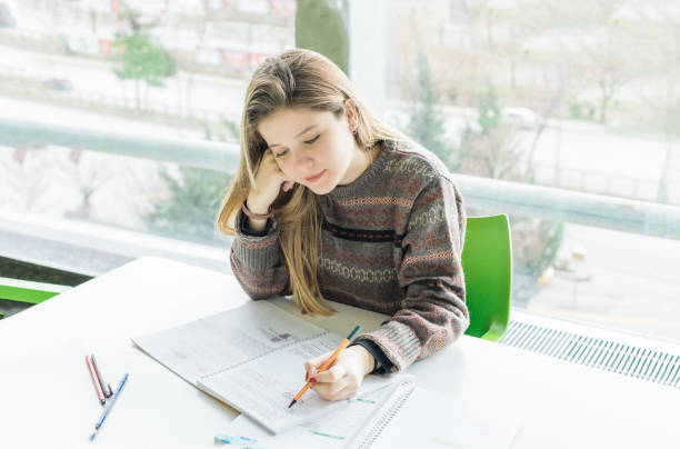 istock Student girl studying in university's canteen 1161986164