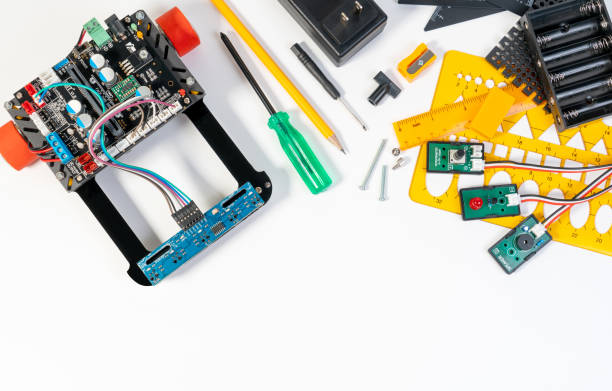 istock Robotics line tracking sensors development closeup and electronic invention engineer, programmer, inventor with cables, wires, robot micro controller board and constructing robot tools. 1161986665