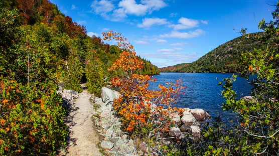 Hiking path along Long Pond with fall colors in Acadia National Park