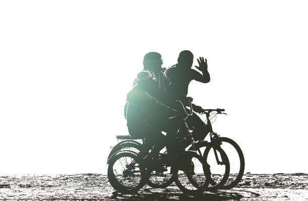 positive family rides bicycles on beach