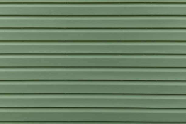 la texture della tavola verde dell'esterno del pannello di rivestimento della casa. linea a strisce astratte parallele - siding house plastic construction foto e immagini stock