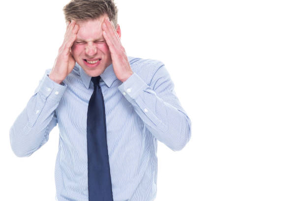 istock Handsome businessman standing on white background - headache 1161995018