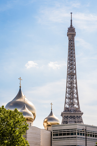Paris, France - July 8, 2019: The Holy Trinity Cathedral is an Orthodox cathedral by french architect Jean-Michel Wilmotte,  topped by golden onion domes, built in 2016 not far from the Eiffel tower.