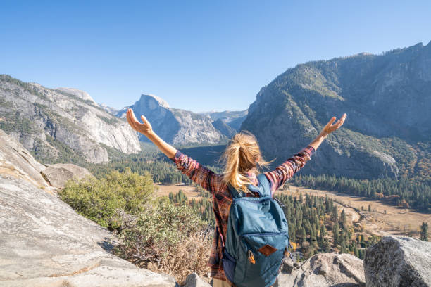 istock Arms wide open, woman embracing nature 1161997925