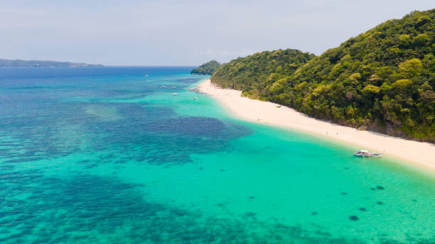 istock Puka Shell Beach. Wide tropical beach with white sand. Beautiful white beach and azure water on Boracay island, Philippines, top view 1161997968