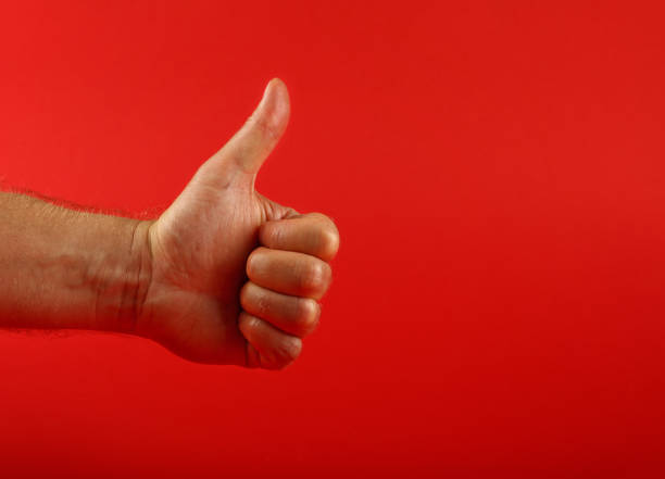 istock Man hand with OK like gesture over red 1162001944