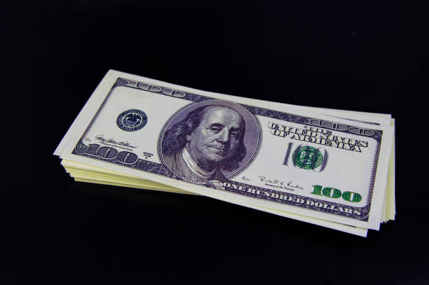 istock Currency American dollars on a black background. 1162002750