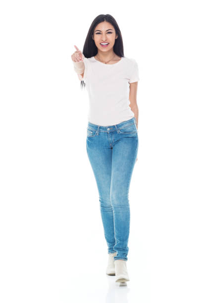 istock Pretty latino female wearing tshirt and jeans - pointing ahead 1162002904