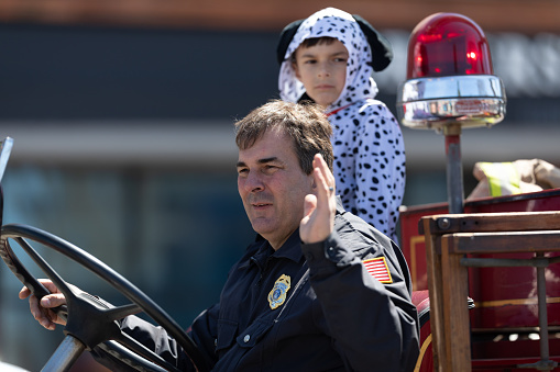 Benton Harbor, Michigan, USA - May 4, 2019: Blossomtime Festival Grand Floral Parade, Man driving an antique St Joseph firetruck during the parade
