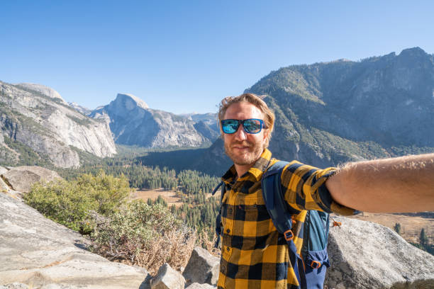 istock Young man taking selfie in Yosemite valley- hiking man 1162004729