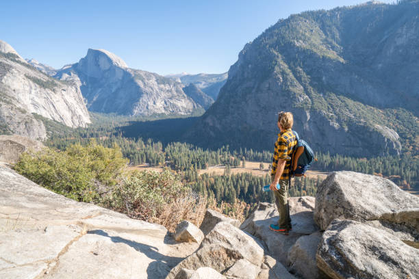 istock Young man hiking in Yosemite valley, USA 1162005132