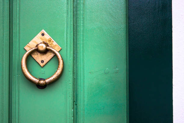 Old wooden doors with an old metal door handle knocker