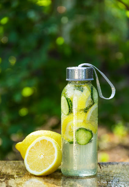 Sassy water. Detox water with lemon. Bottle of cold water with lemon stock photo