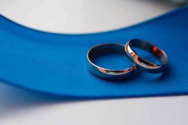 istock old wedding rings on blue ribbon 1162011788