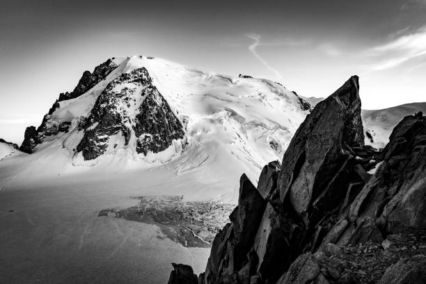 Mont Blanc du Tacul peak ridge beautiful landscape view from Cosmiques hut.  Black and white sunset photo. Alpinism mountain climbing Mont Blanc massif, Europe Alps.