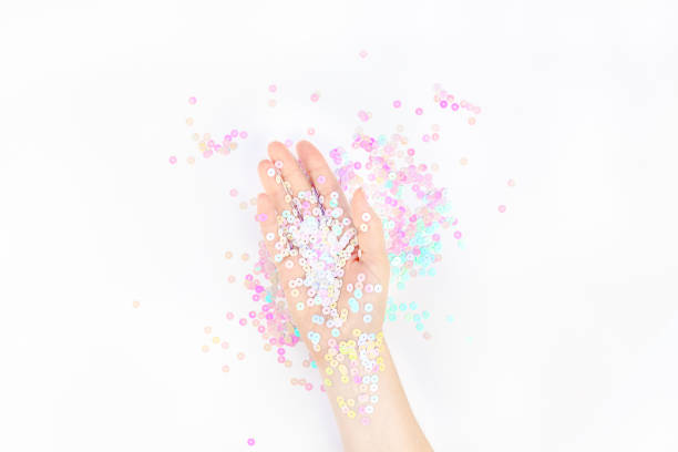 istock Pearl pastel confetti sparkles with woman hand 1162015659
