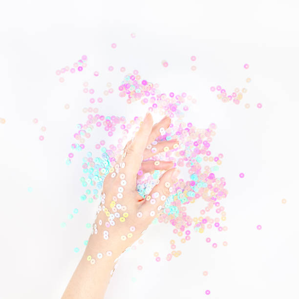 istock Pearl pastel confetti sparkles with woman hand 1162015676
