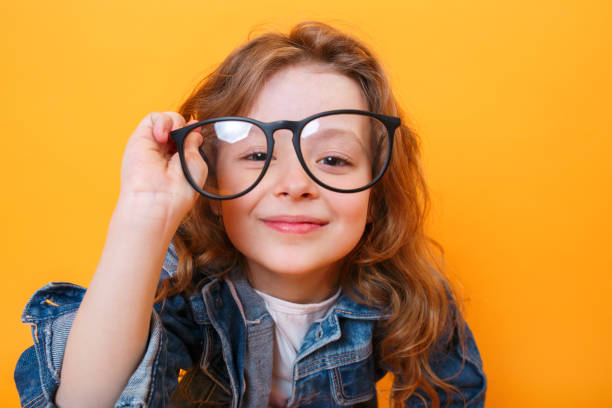 istock Funny curly girl in black glasses on a colored background 1162018258