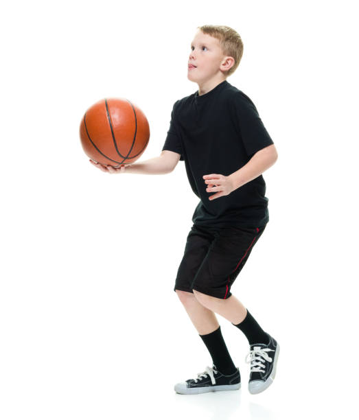 istock 8 year old boy with a basketball 1162019488
