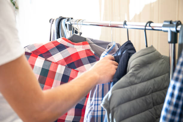 istock man chooses what shirt to wear 1162020623