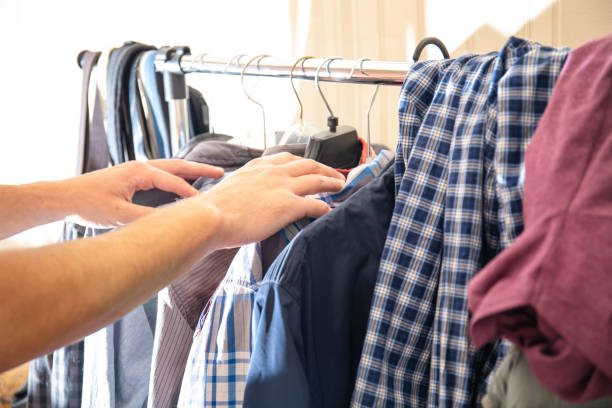 istock man chooses what shirt to wear 1162020628