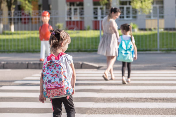 istock Back to school education concept with girl kids, elementary students, carrying backpacks going to class 1162024845