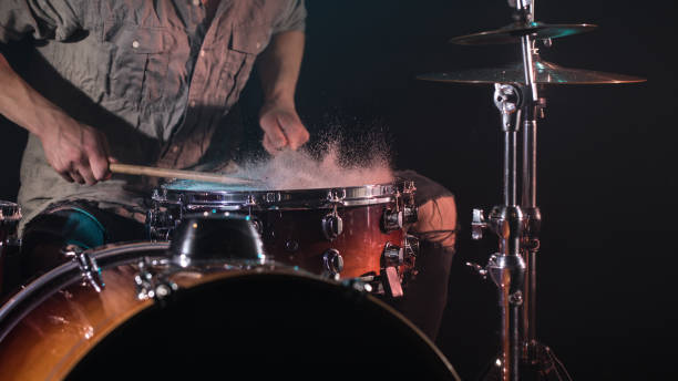 istock musician playing drums with splashes, black background with beautiful soft light 1162025197