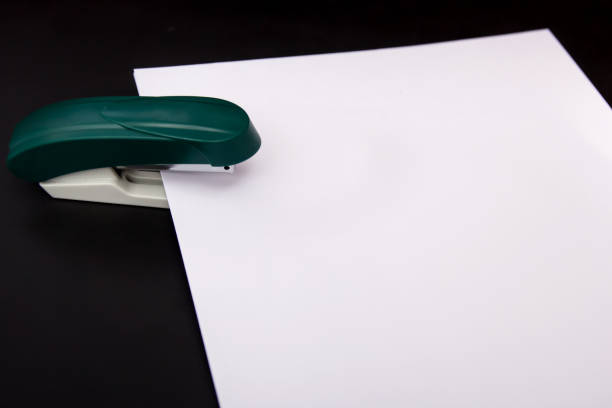 istock stapler and a sheet of paper 1162027341